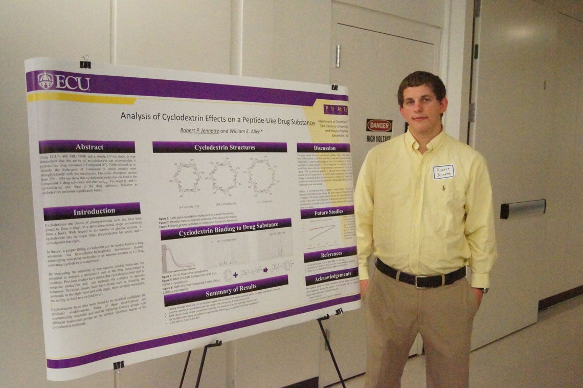 Robert Jennette standing next to his poster on Analysis of Cyclodextrin Effects on a Peptide-Like Drug Substance.