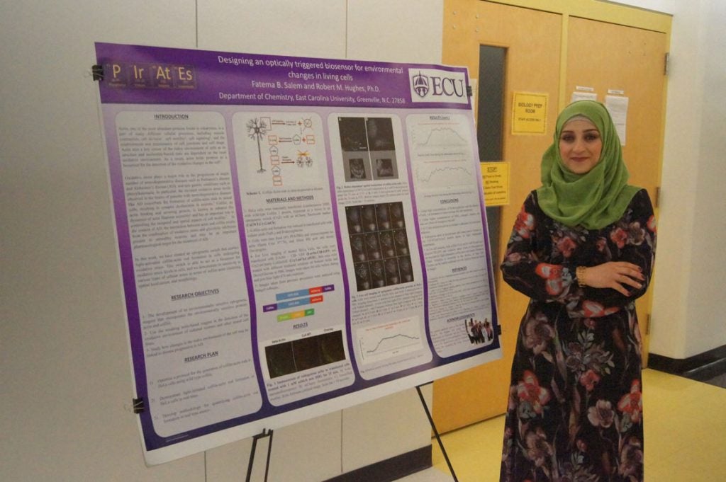 Fatema Salem with her poster about Designing an optically triggered biosensor for environmental changes in living cells.
