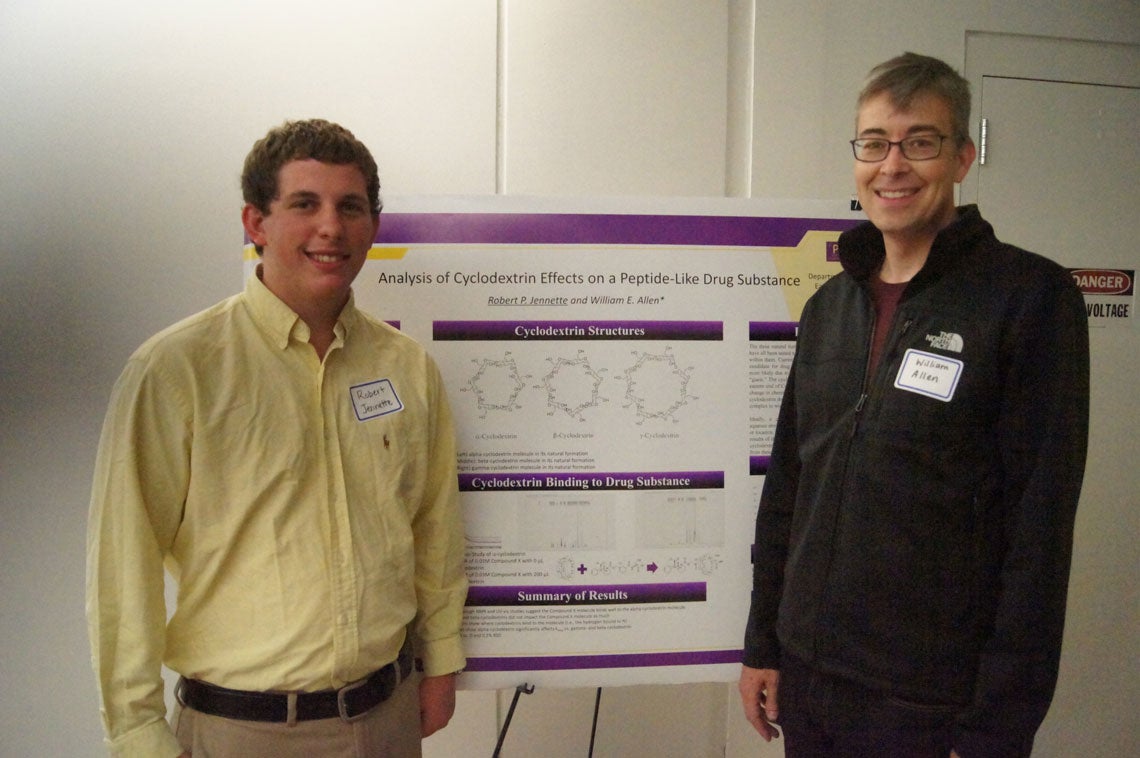 Robert Jenette and William Allen standing next to their poster about Analysis of Cyclodextrin Effects of a Peptide-Like Drug Substance.